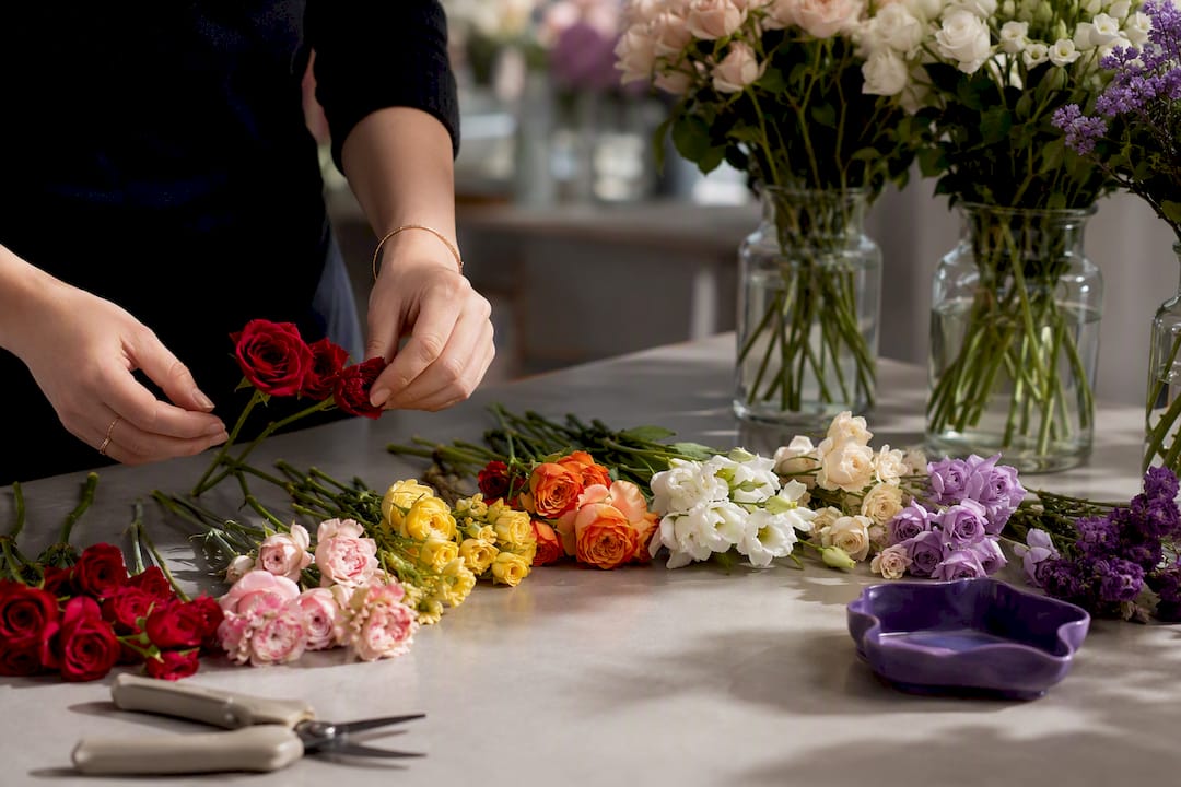 Florist sorting flowers by color