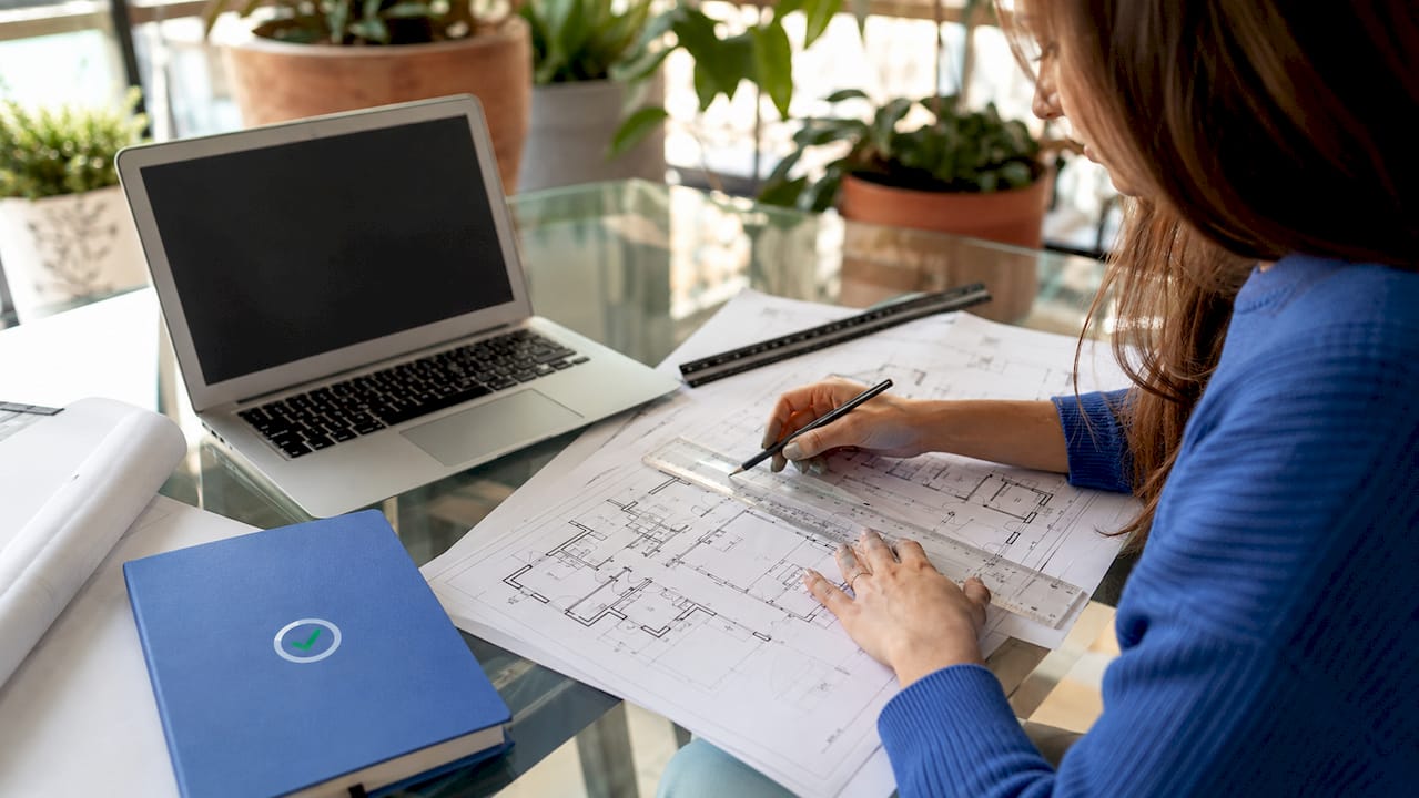 Architect hands examining structural floor plans