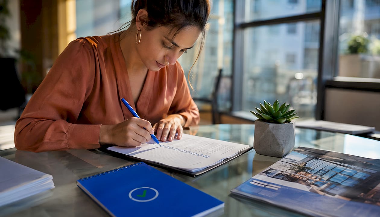 Hands checking MEP permit submission checklist