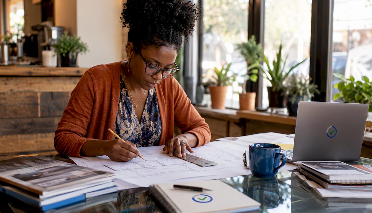 Architect reviewing blueprints in office