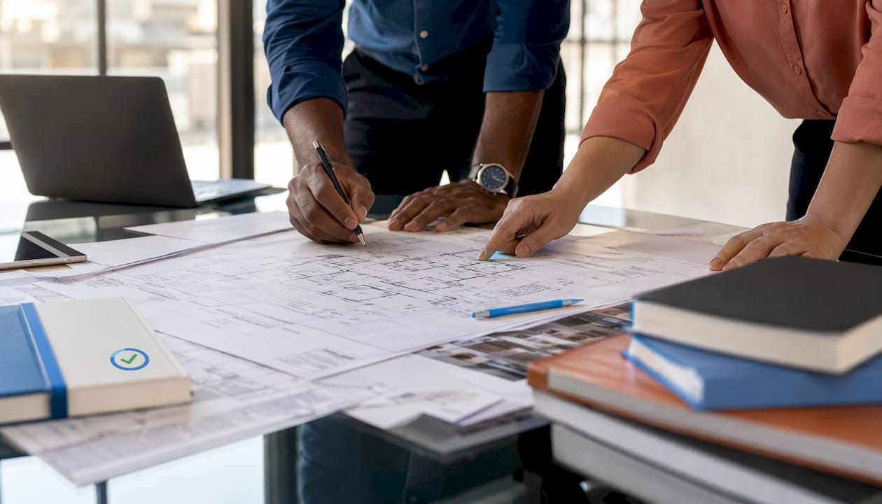 Close-up of architect’s hands with building plans