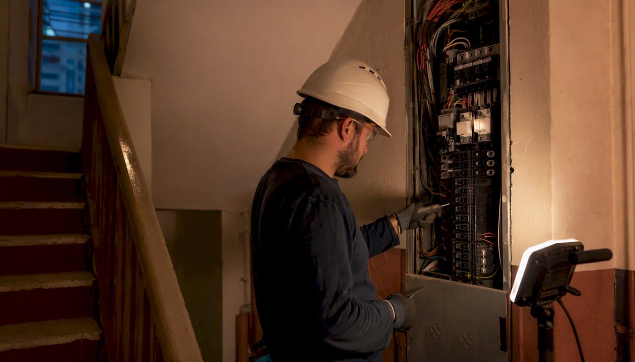 Engineer testing electrical panel wiring