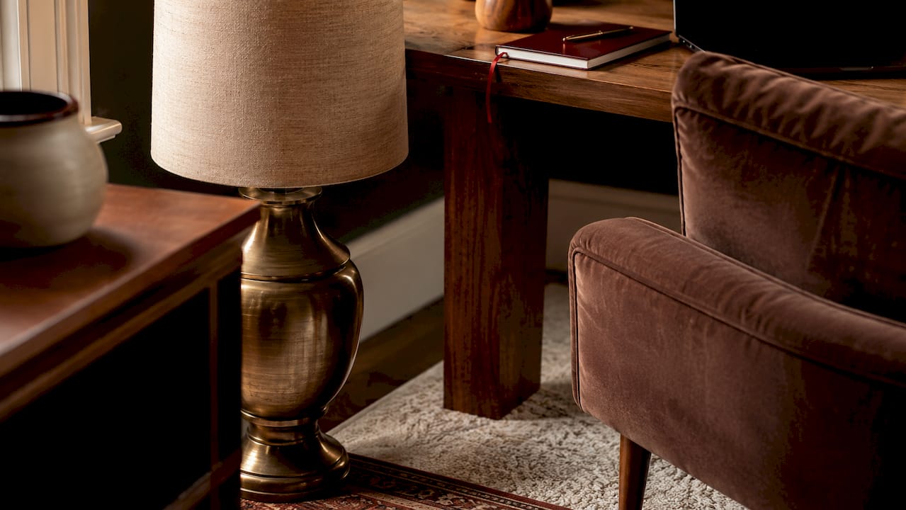 Close-up of coordinated lamp base and furniture tones