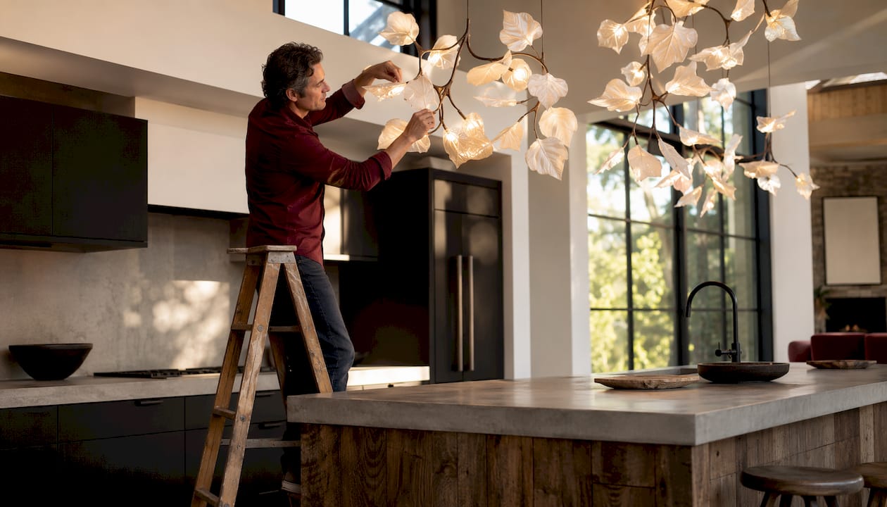 Designer adjusting porcelain leaf ceiling fixture