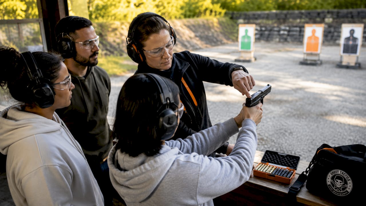 Instructor coaching shooter on trigger control and sight alignment