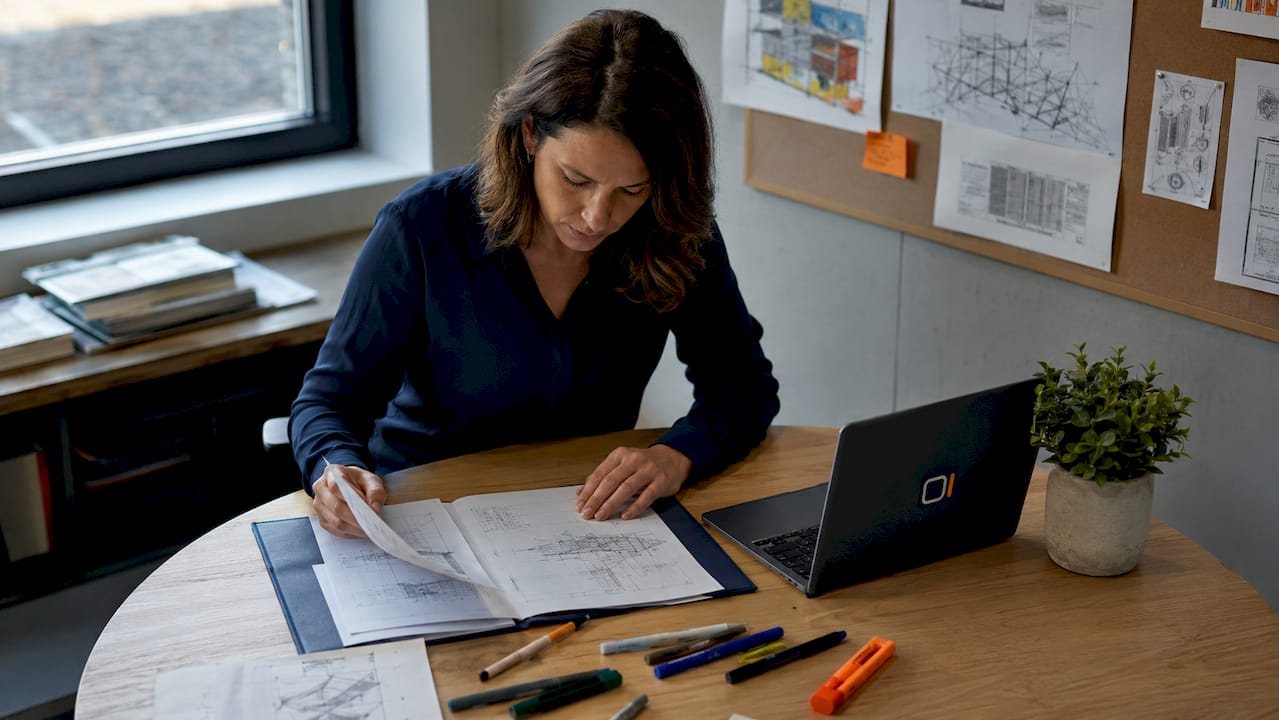 Engineer reading design brief document