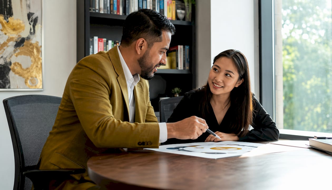 Manager coaching employee in private office