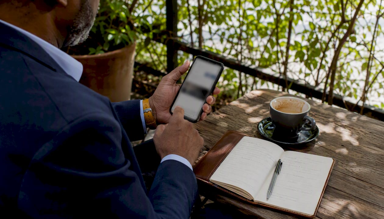 Man using engagement app outdoors at picnic table