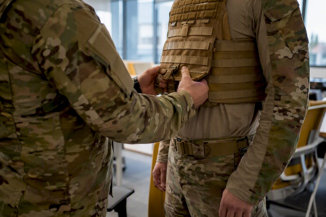 Leader adjusting tactical vest showing care
