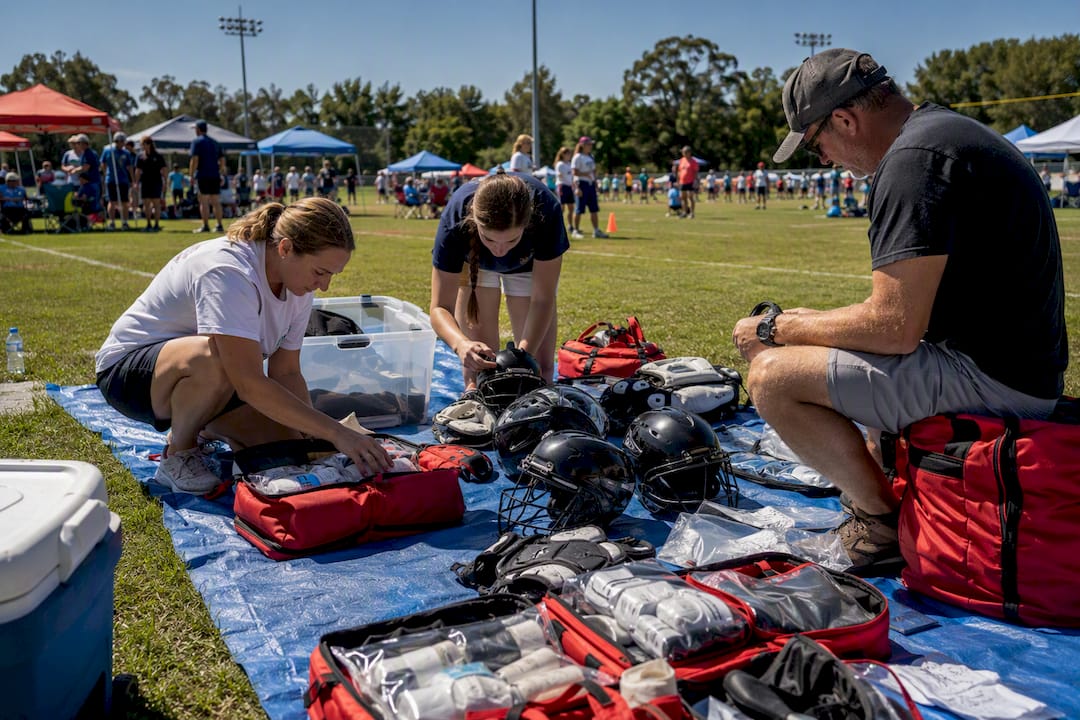 Hands organizing safety gear for sports event