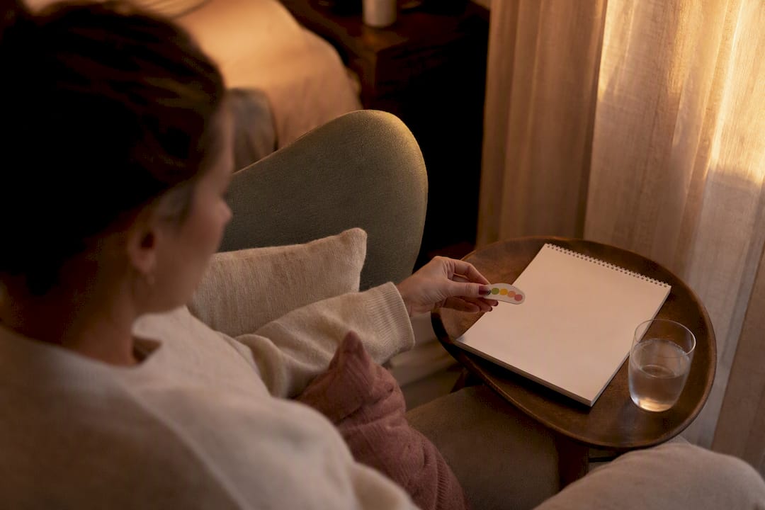 Hand holding pain scale token on nightstand