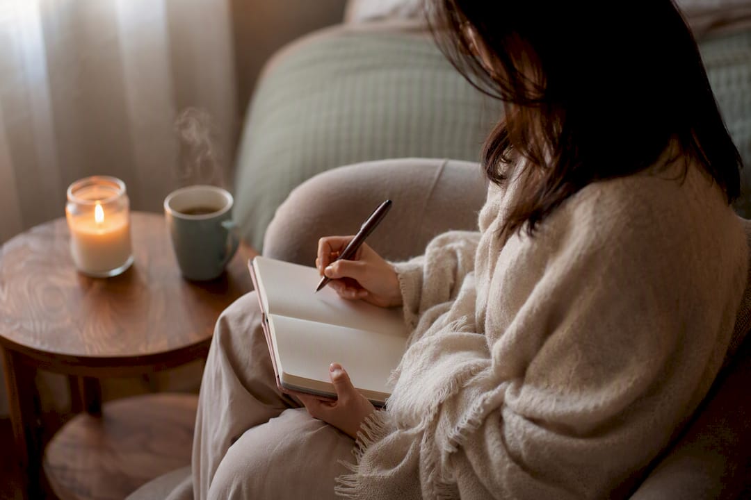 Woman journaling PMS lifestyle tracking