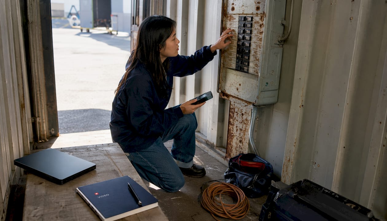 Location scout inspecting electrical breaker panel