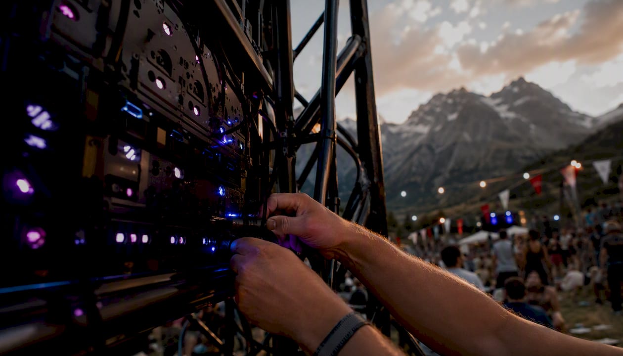 Hands connecting DMX cable to LED panel rig