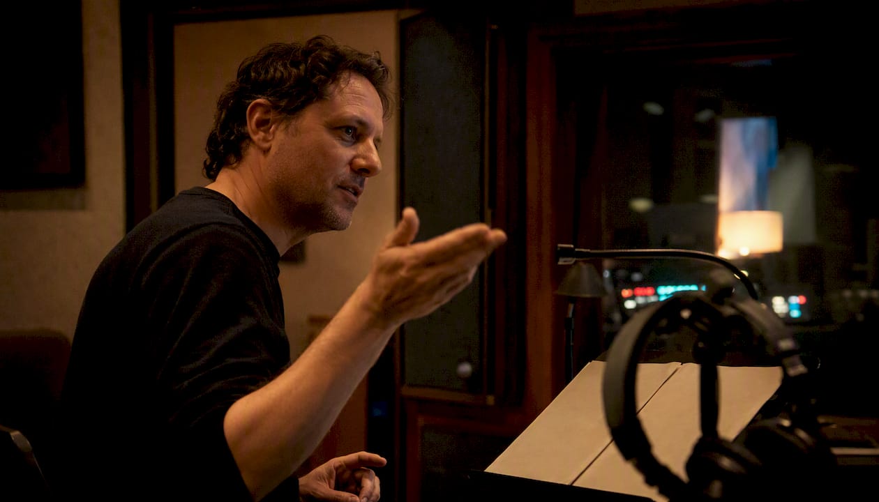 Voice director giving instructions in recording booth