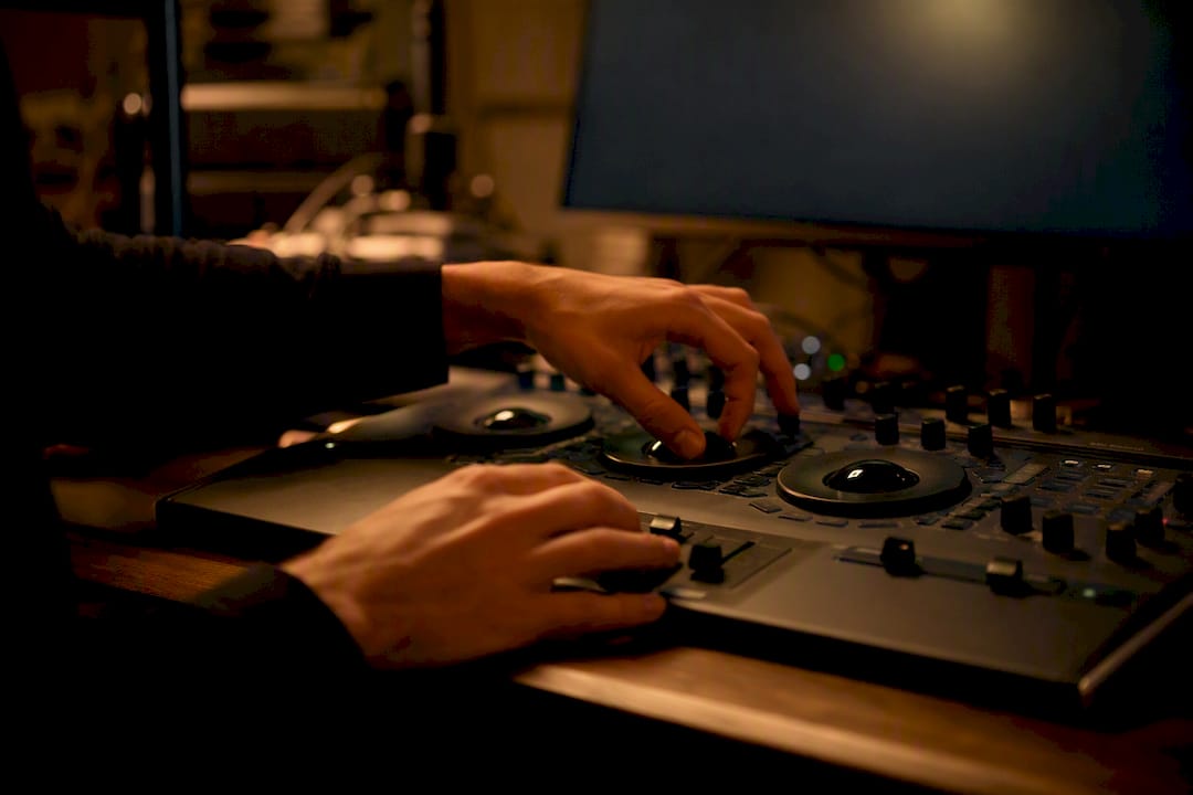 Video editor hands adjusting controls in studio