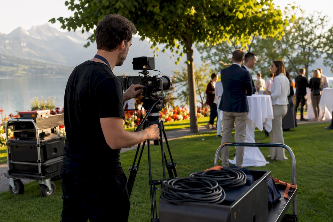 Video crew adjusting camera setup outdoors