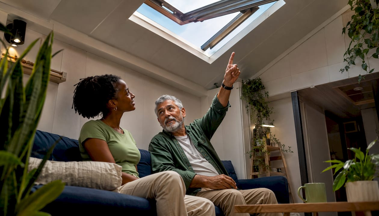 Elderly man and young woman discussing venting skylight