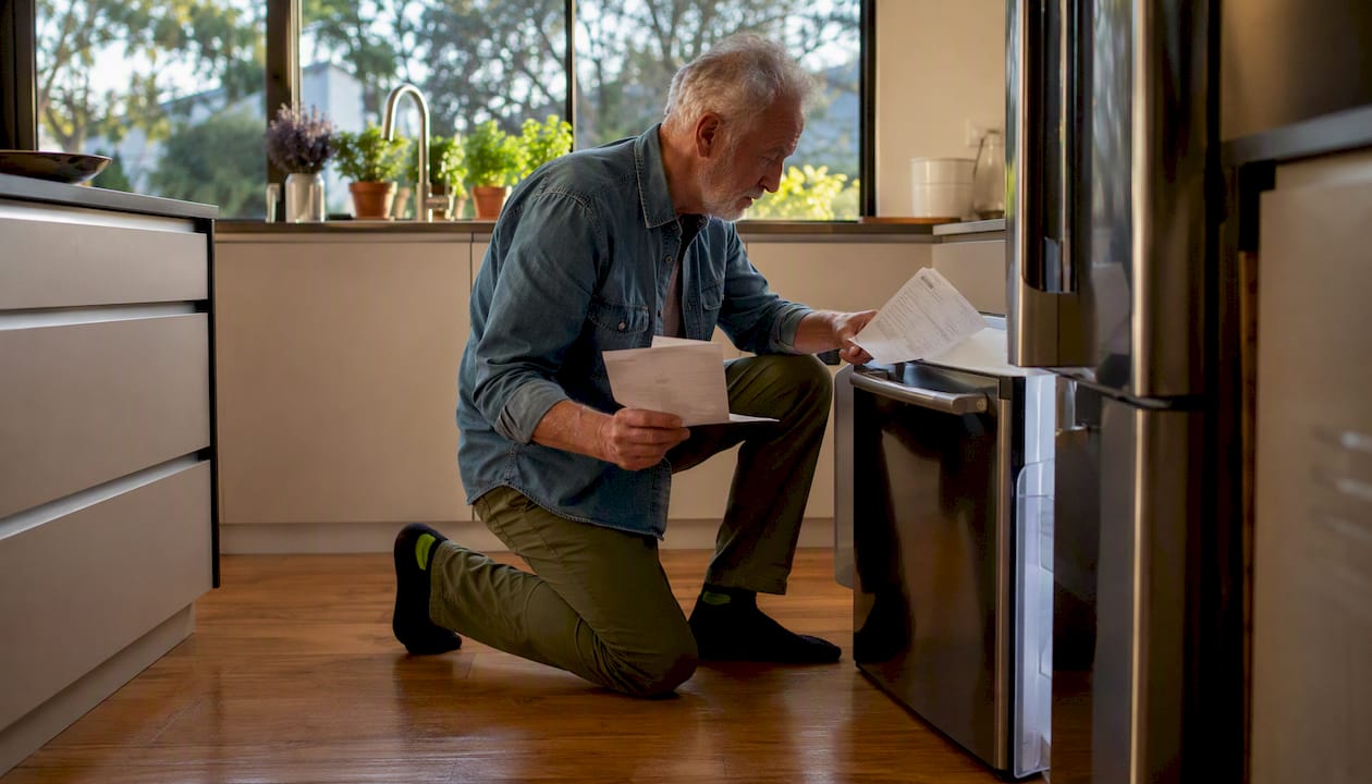 Man reviewing durable refrigerator’s warranty details
