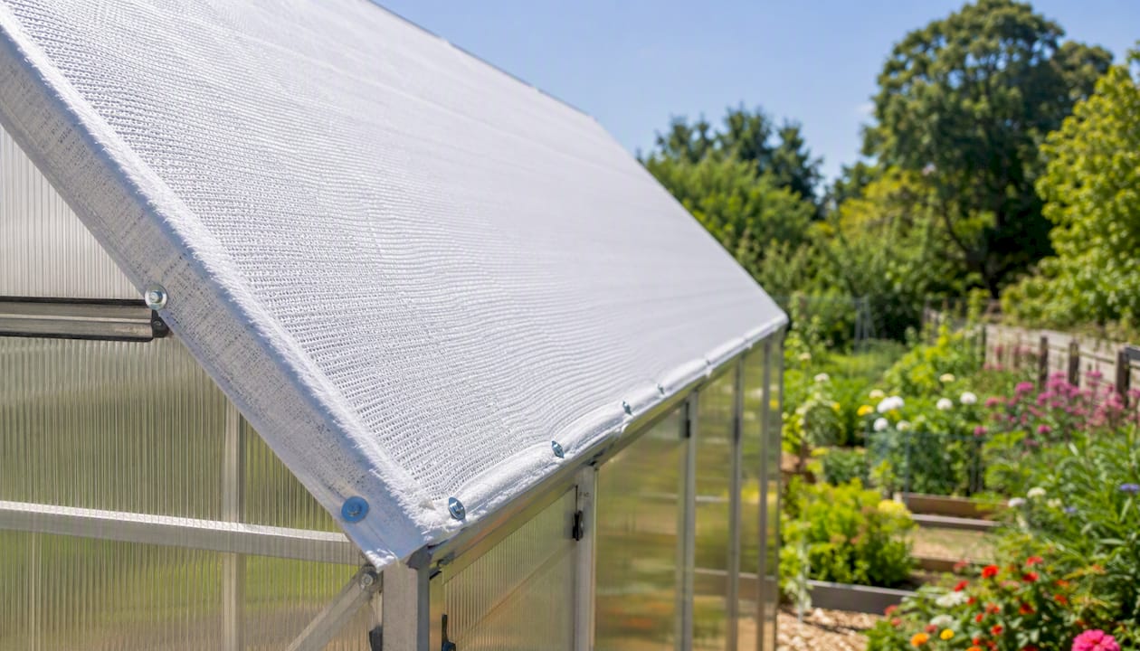 Aluminet shade cloth mounted on greenhouse exterior