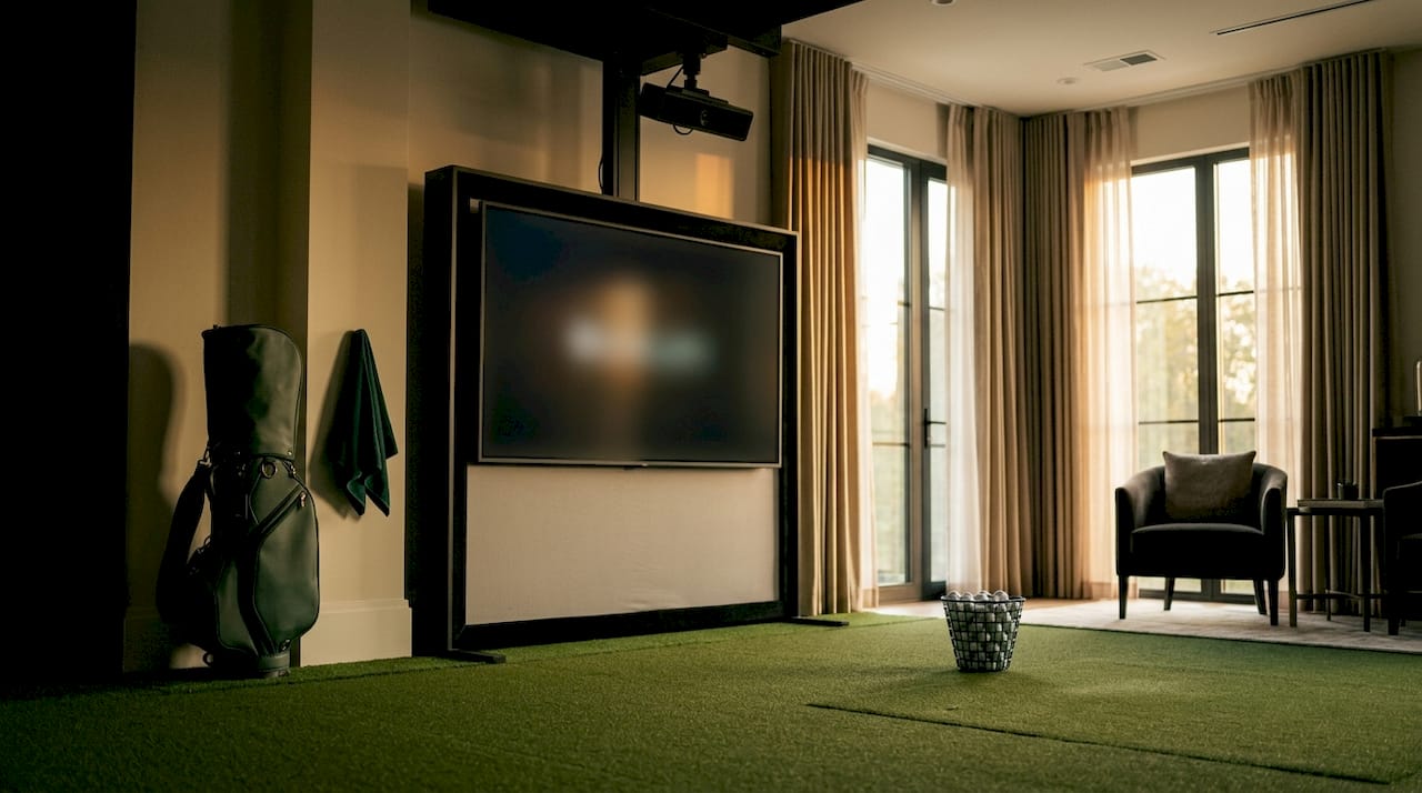 Wide view of home golf simulator room setup