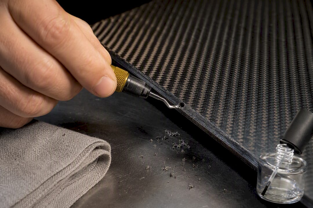 Deburring drilled hole in carbon-fiber hood