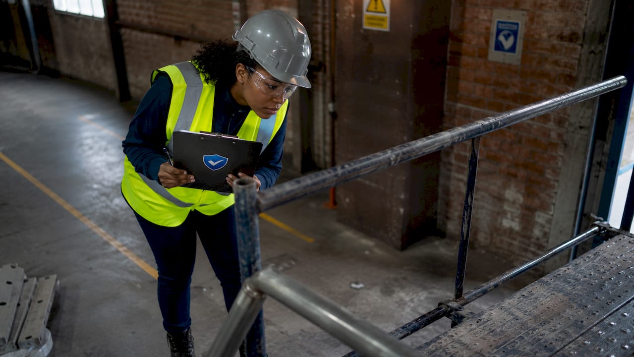 Engineer inspecting scaffold for safety hazards