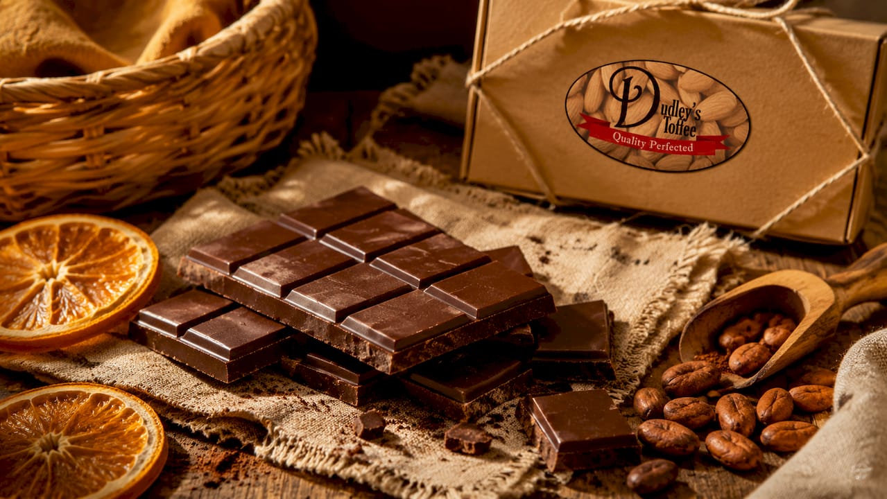 Dark chocolate bars unwrapped on marble countertop