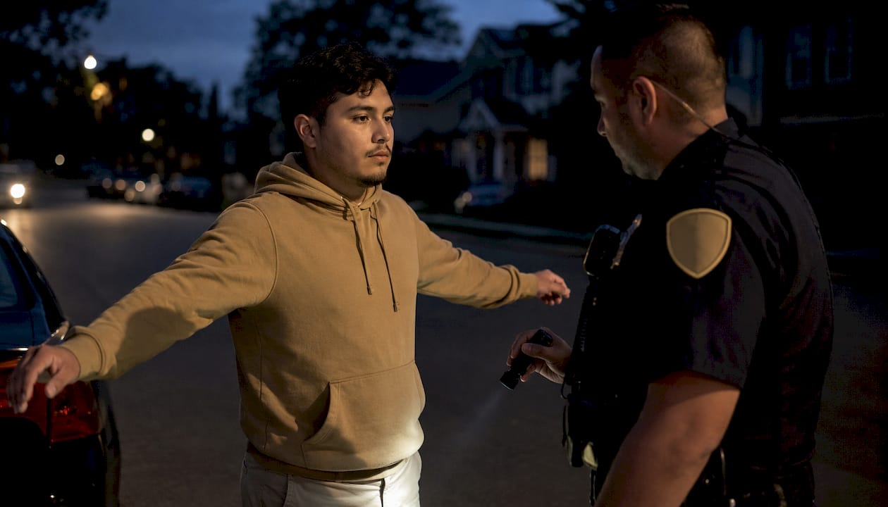 Young male driver undergoing sobriety test outdoors