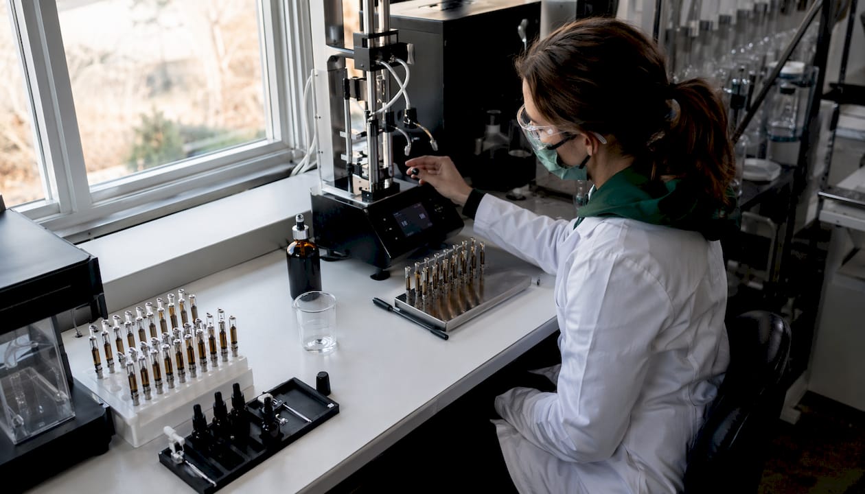 Technician preparing cannabis vape cartridges in lab