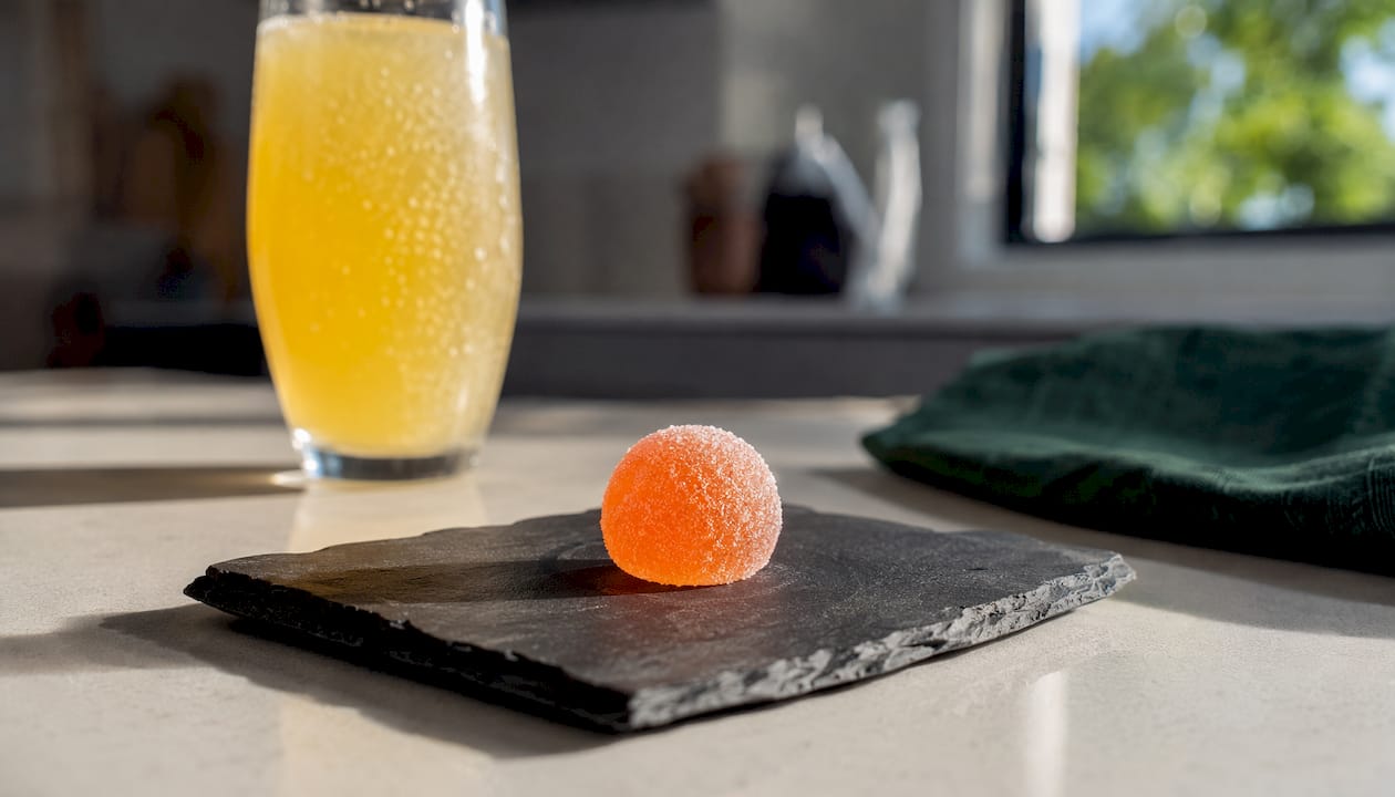 Close-up of peach mimosa gummy on plate