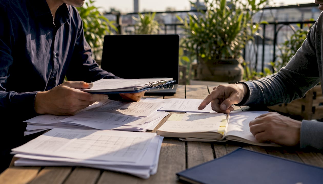 Hands organizing house arrest compliance paperwork
