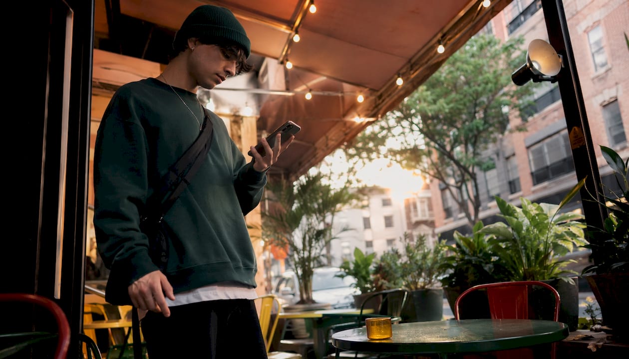 Person checking delivery info at subway station
