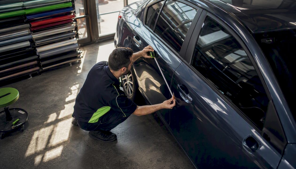 Hand measuring sedan door panel accurately