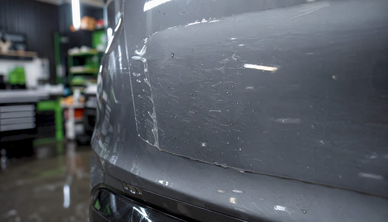 Paint protection film covering rock chips on car bumper