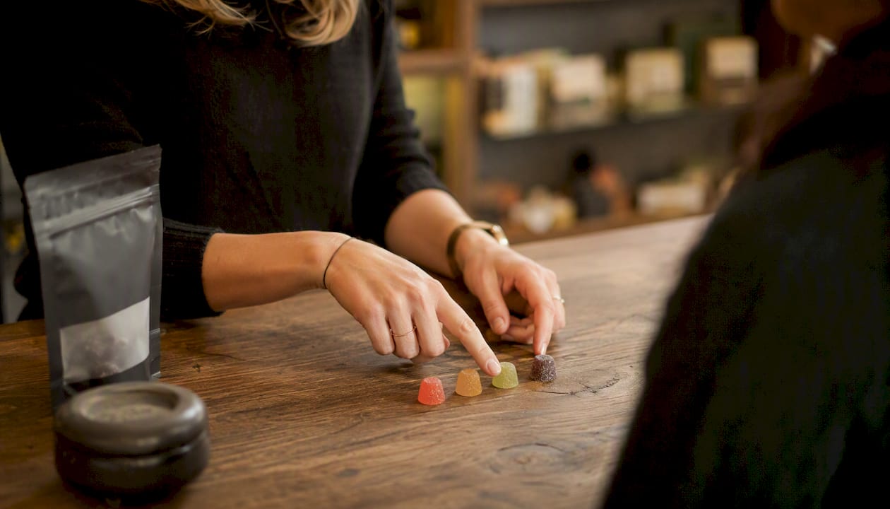 Hands demonstrating edible portion control in dispensary