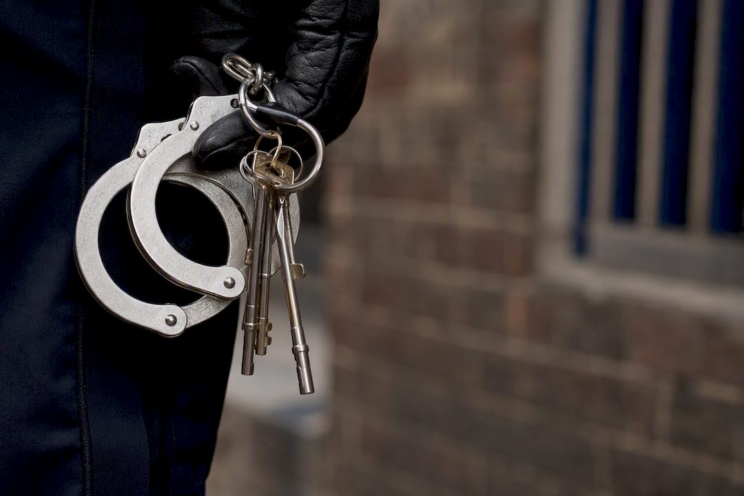 Officer holding handcuffs and jail keys
