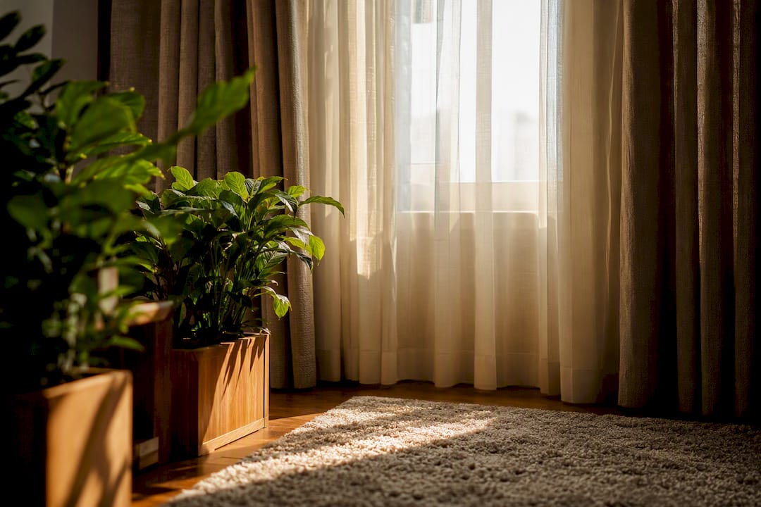 Bay window with sheer panels and drapery layered