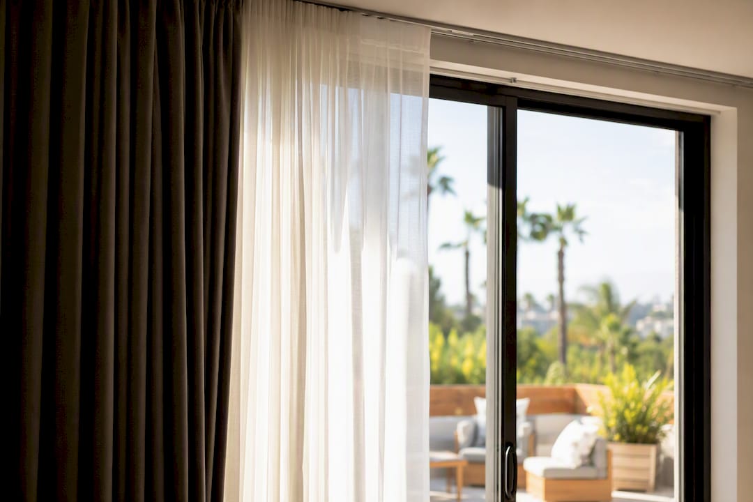 Sliding door with layered sheer and blackout curtains