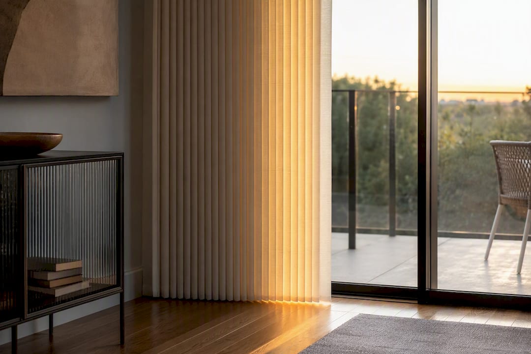 Vertical cellular shades on sliding door filtering sunlight