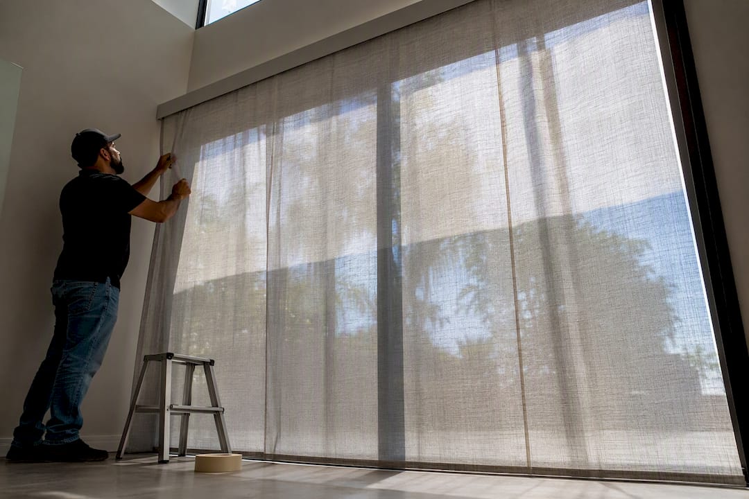 Technician applying frosted privacy film on sliding door