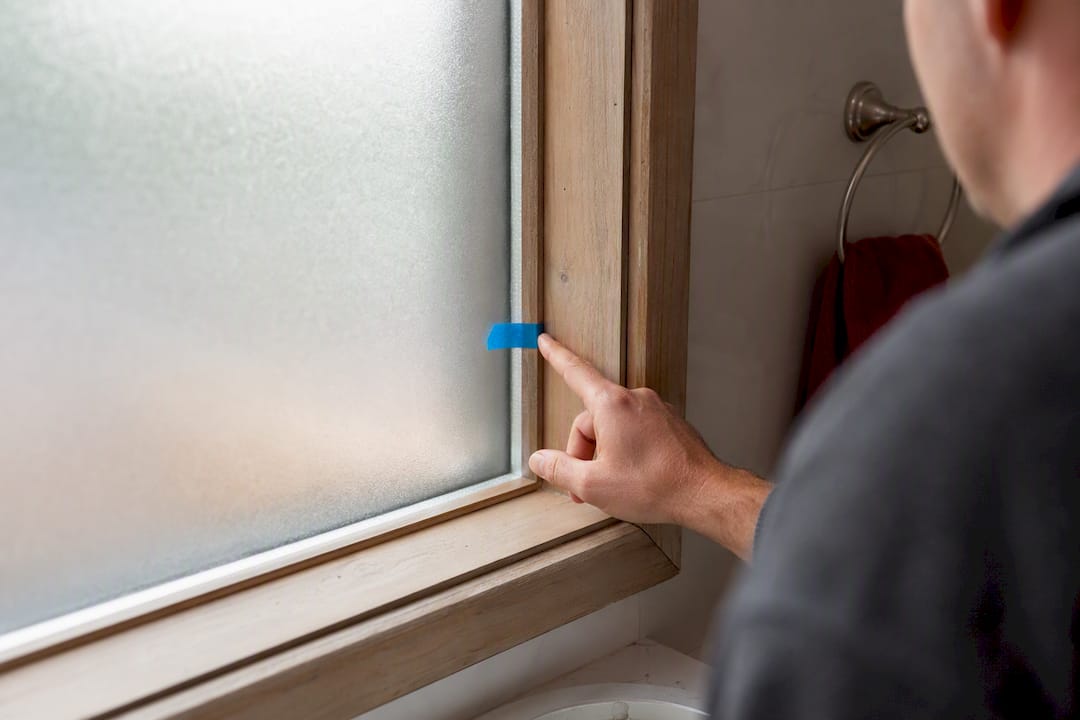 Window film edge gap with painter's tape in bathroom