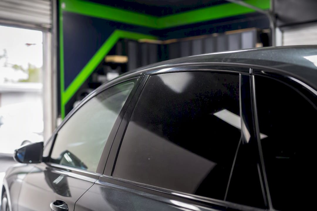 Dark rear car window tint in workshop
