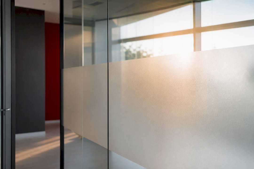 Glass partition with partial frosted privacy film