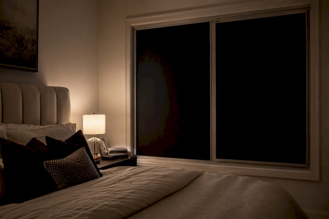 Blackout window film blocking light in bedroom at night