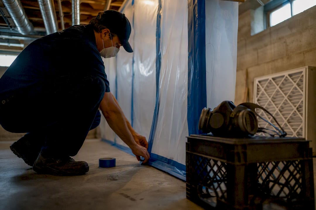 Technician setting containment barriers indoors