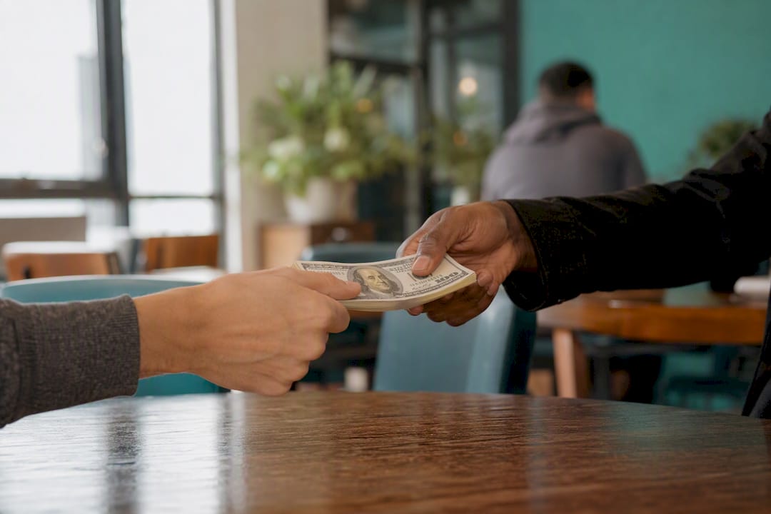 Hands exchanging money for bail bond
