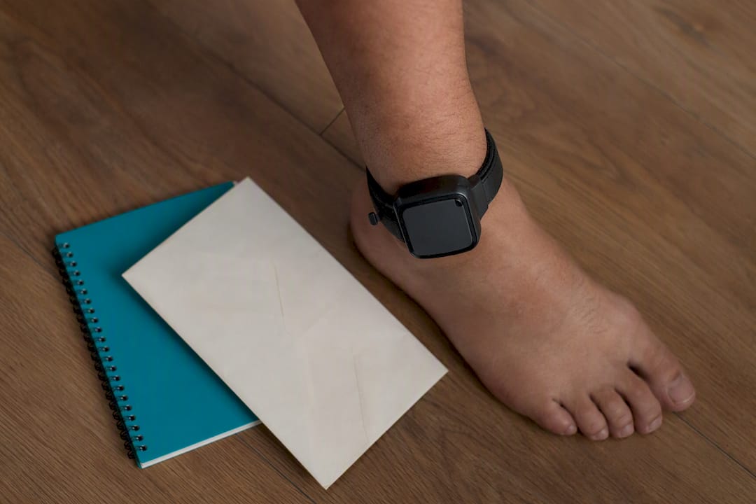 Ankle monitor worn on ankle indoors