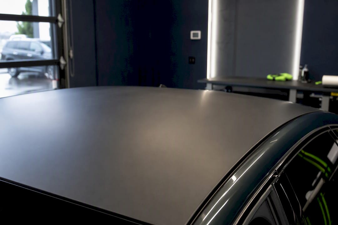 Climate-controlled wrap shop environment with vehicle roof detail