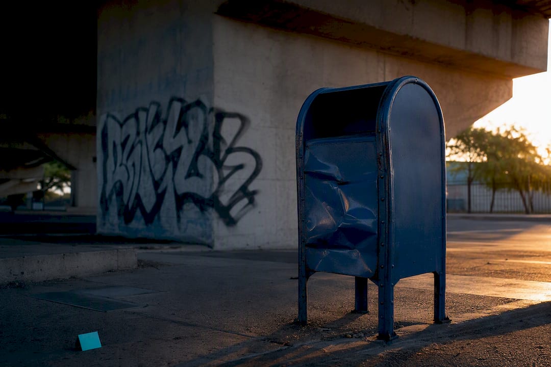 Graffiti and dented mailbox showing property damage